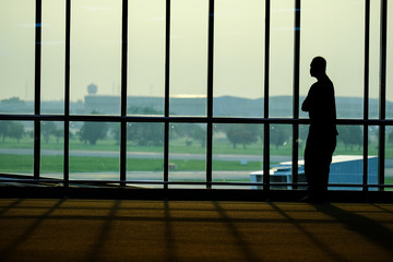 Fototapeta na wymiar Silhouette of people in the airport / Silhouette of people in the airport at morning time, Thailand