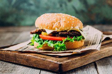 Delicious Fresh Tasty Burger on Wooden Table Background. Copy space. Fast food. Unhealthy food.