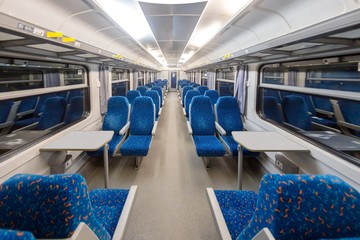 Empty train interior with blue chairs