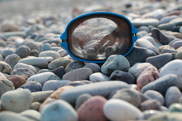 Fototapeta na wymiar mask for scuba diving on a pebble beach