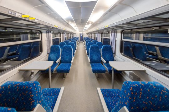Empty train interior with blue chairs