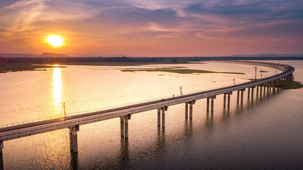 Fototapeta na wymiar Railroad bridge Over River Pa Sak Dam Lopburi Thailand and Beautiful sunset