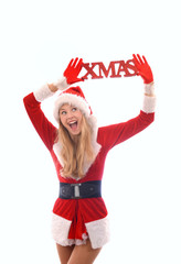A young girl dressed in a Santa Claus suit holds a red sign up high above her head which reads the...