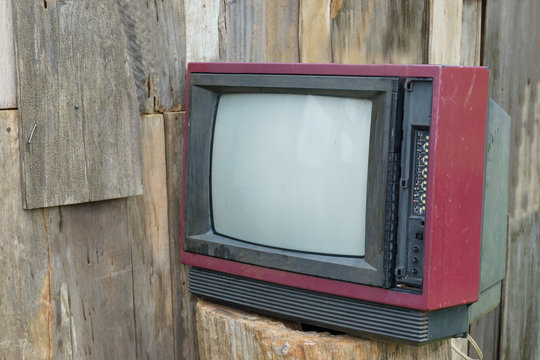 old vintage television on wood trunk