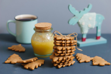 Ginger cookies with honey, tea and moose on the grey and blue background