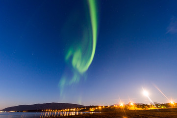 Naklejka na ściany i meble the polar lights over the city of Tromso