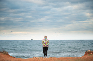 adult woman looking to the sea
