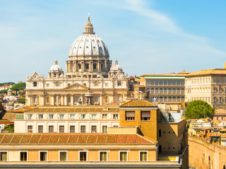 Fototapeta na wymiar View of the St Peter's Basilica in Vatican City and roofs of Rome, Italy