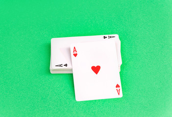 Ace with a deck of cards on a green background.