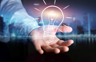 Businessman holding a sketch lightbulb