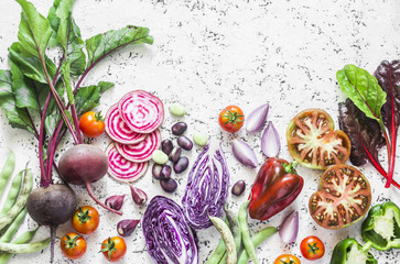 Variety of vegetables a light background. Beets, red cabbage, beans, tomatoes, red onions, peppers...