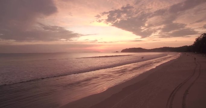 Surfer on The Beach at Sunset on Koh Phayam in Thailand, Push-in Aerial Shot
