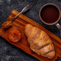 Fresh croissant on dark background.