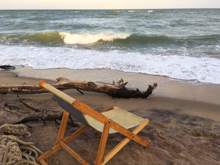 Chaise lounge on beach at the sea. Sunset. Lifestyle, relaxing summer evening at the beach resort....