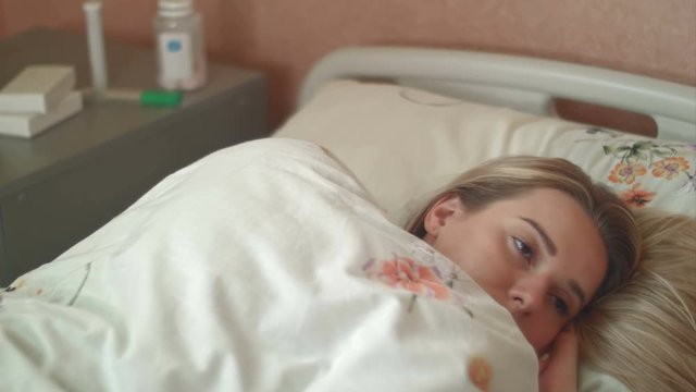 Female patient wakes up in a hospital bed