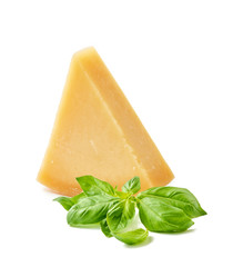 Parmesan cheese with basil leaves on white background. Italian cheese slices.