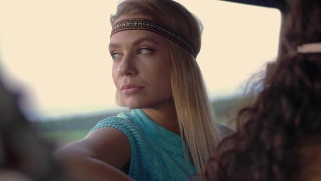 Beautiful pensive hippie girl in a van