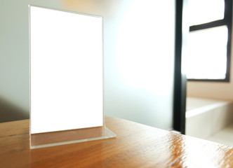 Mock up Menu frame standing on wood table in Bar restaurant cafe. space for text.