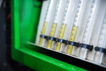 A close-up diagnostic stand with fuel flasks for checking the flow rate of the amount of fuel...