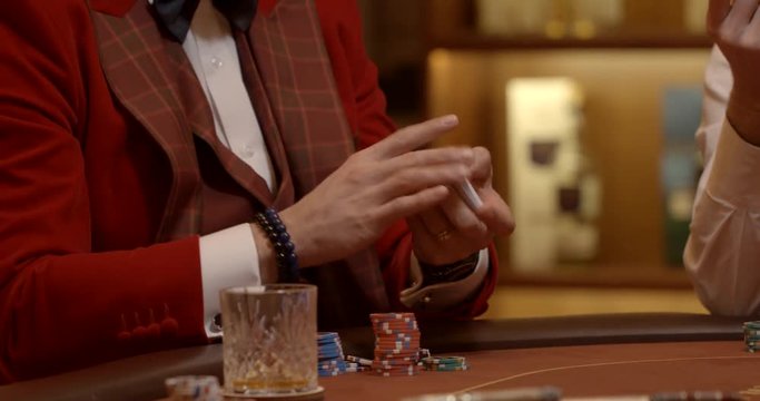 Confident upper class men shuffling cards in gentlemen's club
