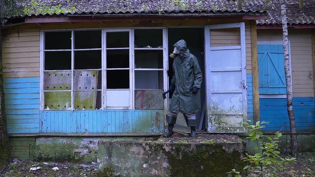crazy stalker maniac with a gas mask guarding the entrance with an ax.