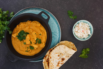 Delicious Indian chicken korma with rice and butter naan, top view