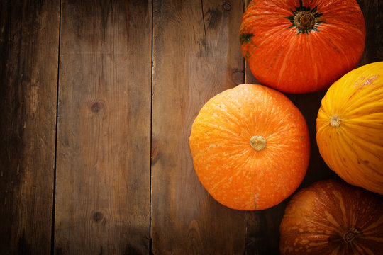 Pumpkins on wooden background. thanksgiving and halloween concept