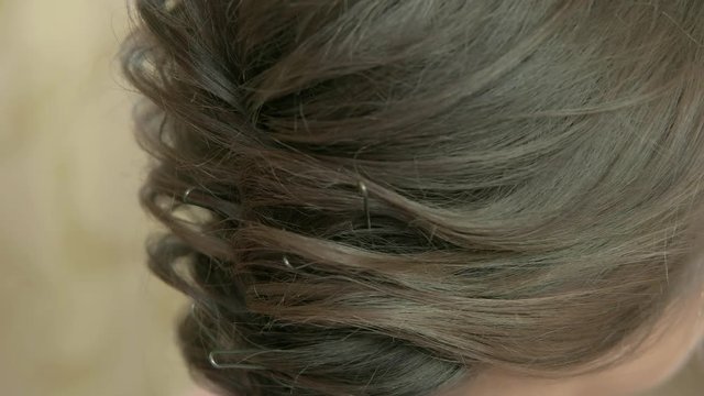 Female hairdo close up. Hair with bobby pins.