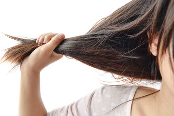 Combing with brush and pulls long hair.Daily preparation for looking nice, Long Disheveled Hair,Holding Messy Unbrushed Dry Hair In Hands.Hair Damage,Health And Beauty Concept,unhappy with dry hair
