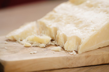 pieces of hard parmesan cheese on olive board