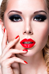 Portrait of beautiful  woman with  red lips and nails.