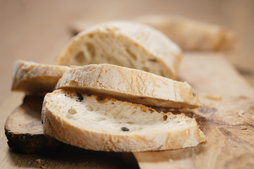 closeup slices of ciabatta on wood board