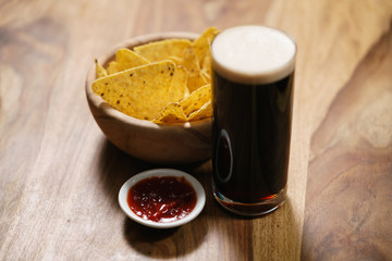 dark beer with nachos and salsa sauce