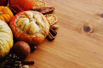 Seasonal wooden table setting with small pumpkins