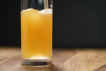 wheat unfiltered beer poured into glass on wood board