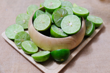 Heap of ripe organic limes cut in half