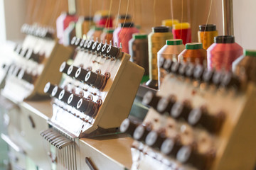 Textile sewing machines in factory hall