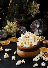 Fototapeta premium popcorn in a wooden plate on the background of Christmas