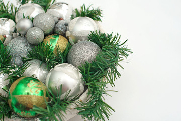 Fototapeta na wymiar A festive Christmas arrangement artificial branches, glass balls in the basket.