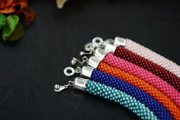 Bead crochet bracelets different colors on a dark background