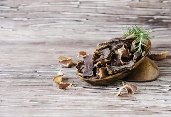 jerked meat, cow, deer, wild beast or biltong in wooden bowls on a rustic table