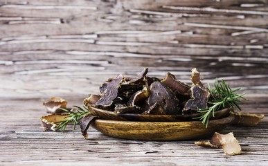 jerked meat, cow, deer, wild beast or biltong in wooden bowls on a rustic table