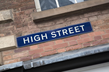 Obraz premium High Street Sign on Brick Wall Facade