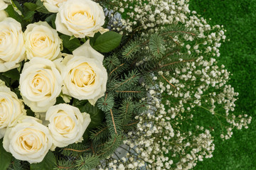 Autumn composition of wild and ornamental flowers . Bouquet on green background of artificial grass.