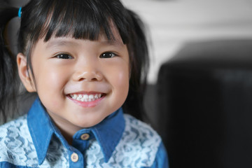 Asian children cute or kid girl wearing jeans or cowboy suit for fashion and smile white teeth with small eye and happy for background with space