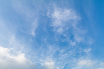 Clear blue sky background with white clouds.