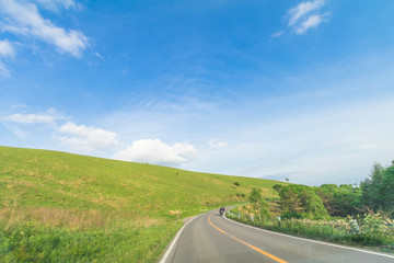 Beautiful  landscape view of  a country road and green grass with  blue sky  background of Utsukushigahara park is  one of the most important and popular natural place in Nagano Prefecture , Japan.