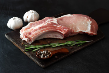 Meat pork topper with rosemary and a spoon of pepper and garlic