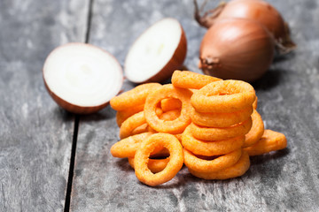 Crispy  fried onion rings on wooden table