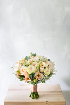 Fototapeta floral composition with roses and mix flowers in glass vase on a gray background.